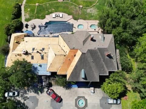Aerial drone view of a roof replacement in progress